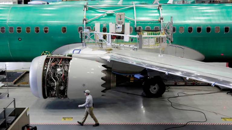 A worker walks past Boeing’s new 737 MAX-9 under construction at their production facility in Renton, Washington, U.S., February 13, 2017. - REUTERSPIX