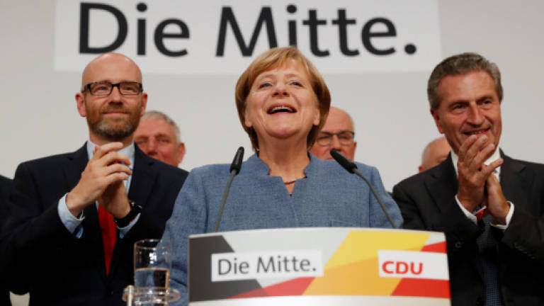 Merkel wins fourth term, hard right gains foothold in parliament