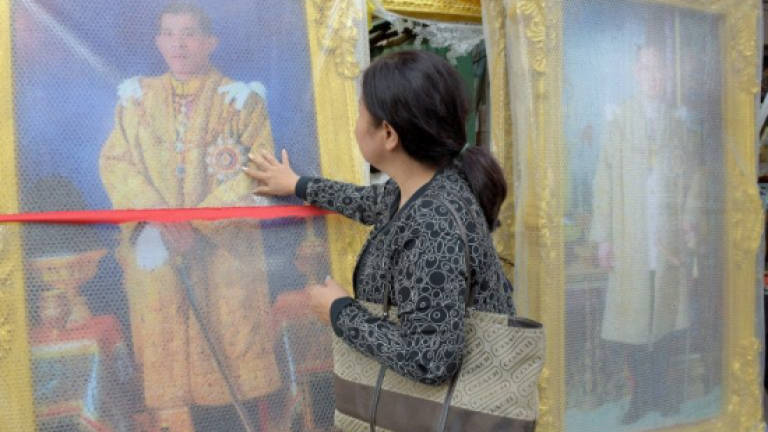 Thai teens handed years-long sentences for burning royal portraits