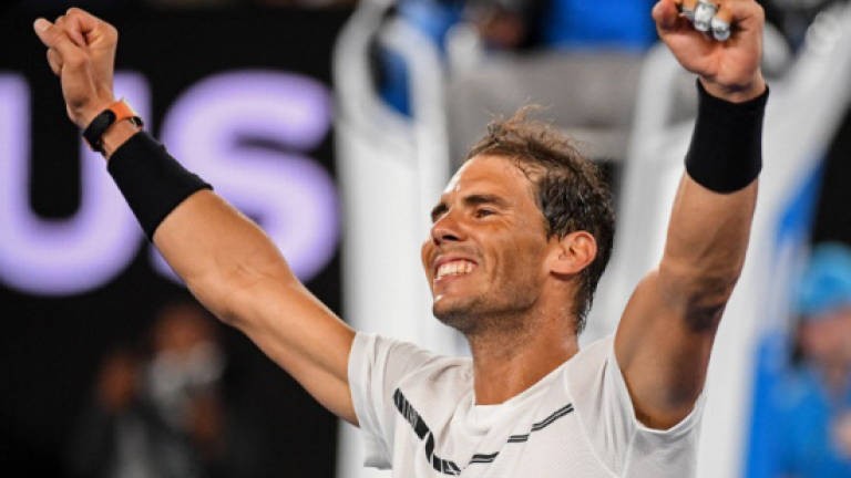 Breathless Nadal, Serena into last eight