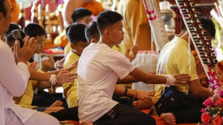 Thai cave boys pray for good luck after first night home