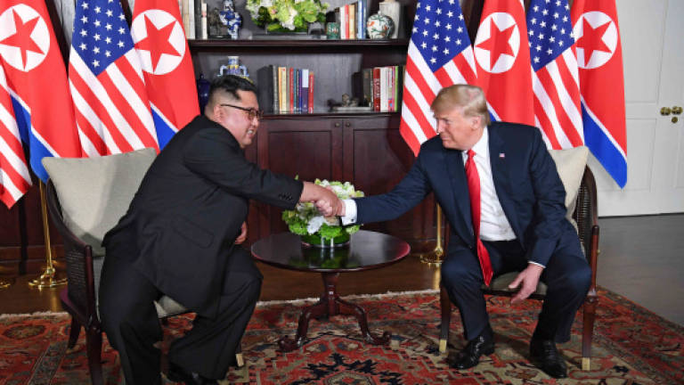 Trump, Kim share historic handshake