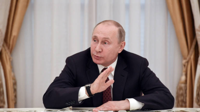 Putin pledges to reduce Russia military spending this year