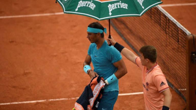 Rain cuts short Nadal fightback, Muguruza crushes Sharapova