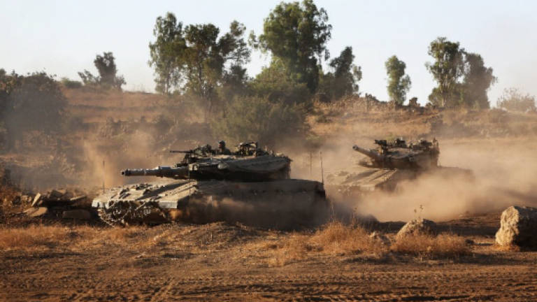 Israel hits Syrian military targets after stray fire on Golan
