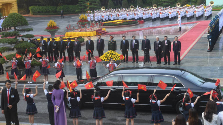 Xi visits Vietnam in bid to improve ties