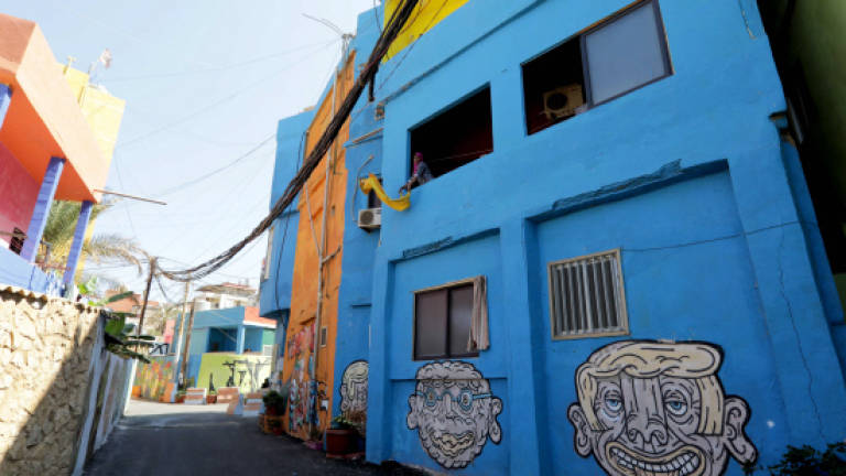 Street art brings colour to rundown Beirut suburb