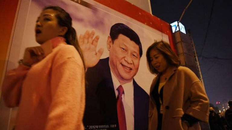 China crowns Xi with name once reserved for Mao Zedong