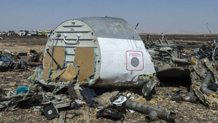 Russian plane broke up 'in the air', bodies flown home from Egypt