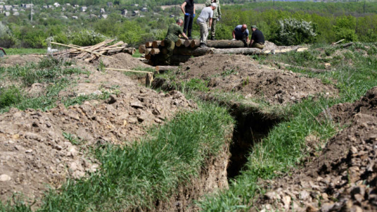 Fearing attack, Russian-backed rebels dig trenches in Ukraine