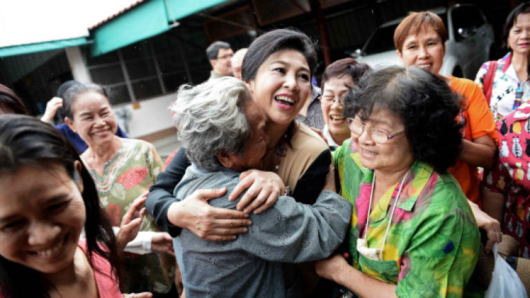 Thai ex-PM Yingluck defies army with selfie and smiles tour