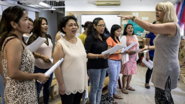 Hong Kong migrant mothers sing for their distant children