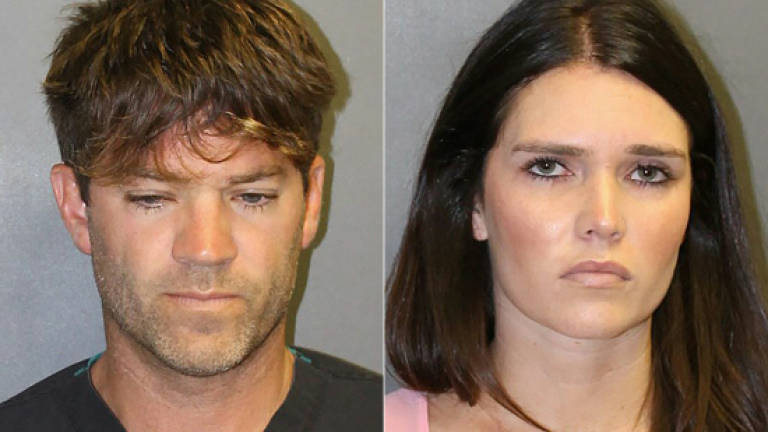 US surgeon, girlfriend charged with rape, 'hundreds' of victims possible