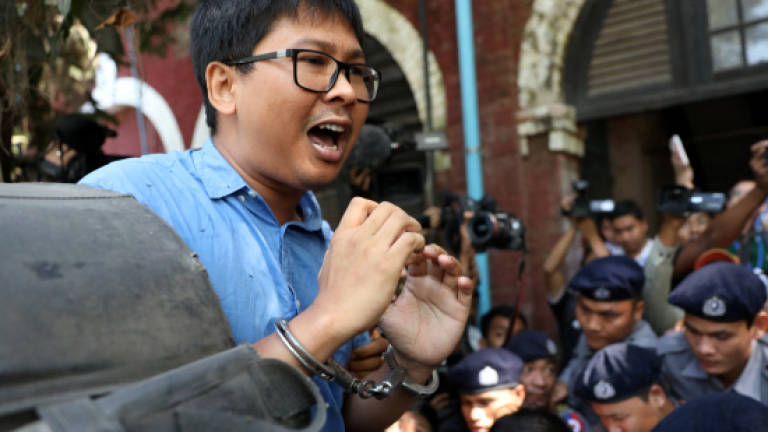 Myanmar police charge Reuters reporters under Official Secrets Act