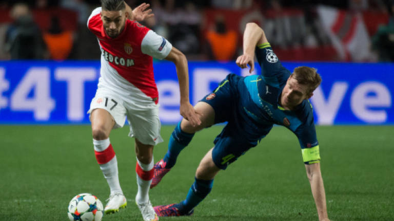 Arsenal win but bow out, Atletico hold nerve
