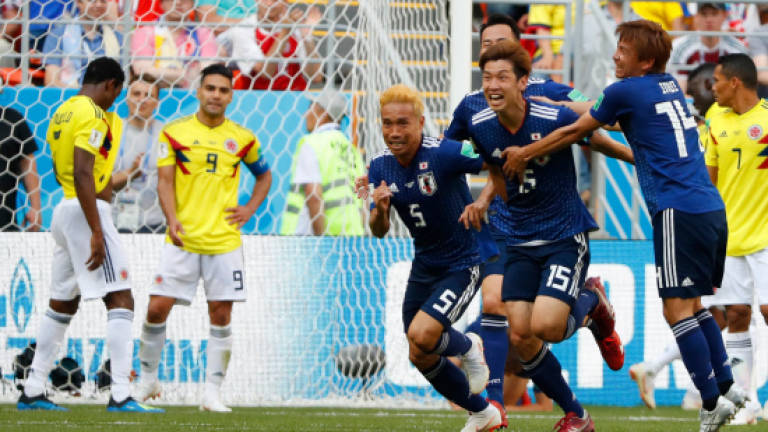 Osako's header lifts Japan past 10-man Colombia
