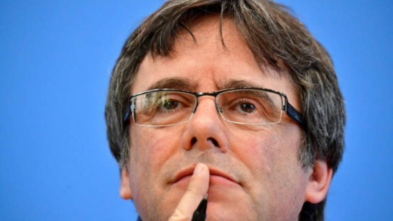 Deposed Catalan leader Puigdemont says to return to Belgium