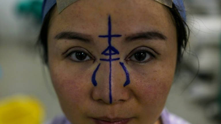 Going under the knife in China's plastic surgery stampede