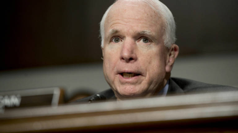 McCain slams Trump for disparaging family of slain soldier