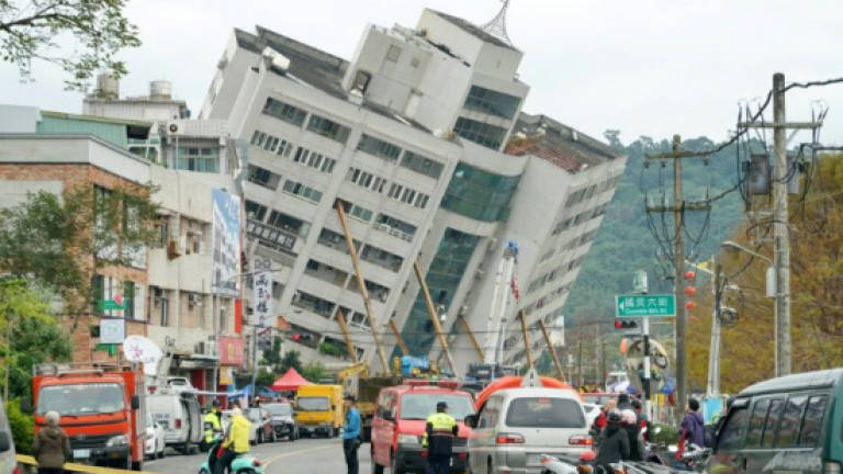 Rescuers scour toppled buildings after Taiwan quake kills seven