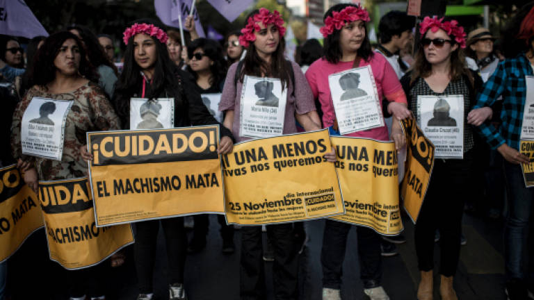 Latin Americans march to condemn violence against women
