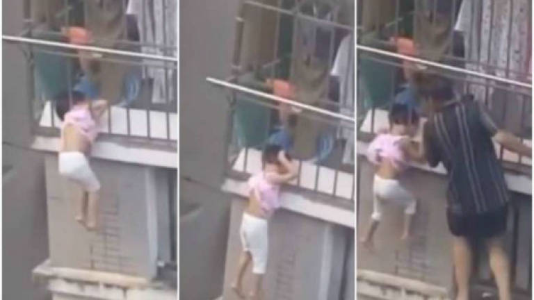 Girl dangling by her neck saved by neighbour