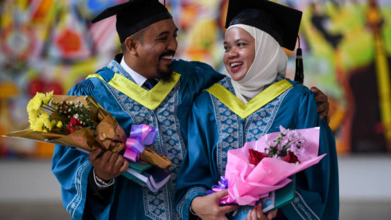 Married couple among graduates receiving degrees at IIUM today