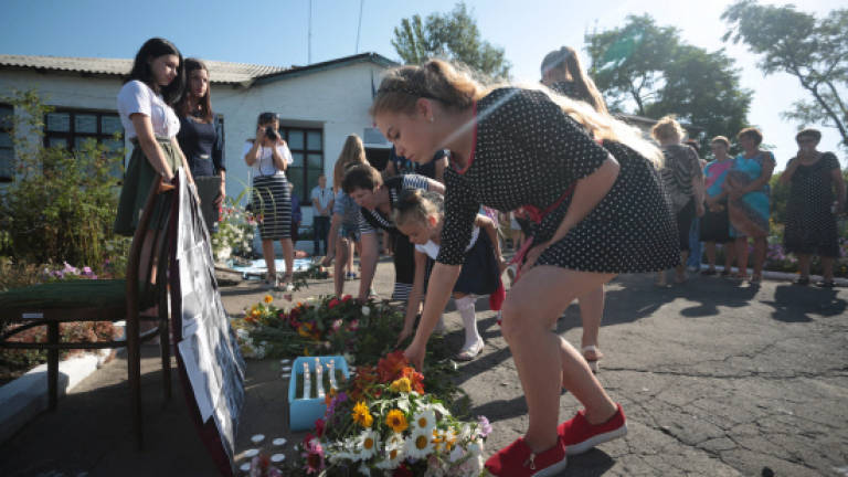 Two years on, Ukraine villagers mourn at MH17 crash site