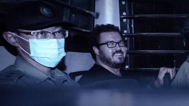 UK banker on double murder charge grins leaving Hong Kong court
