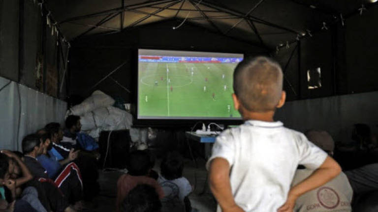 Displaced Syrians find relief in tent-side World Cup screenings