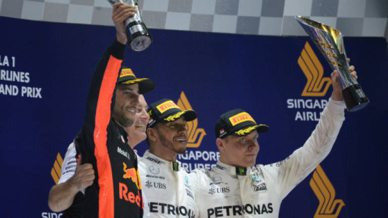 Hamilton wins crucial, chaotic Singapore GP
