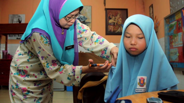 Overcoming obstacles: Determined students sit for UPSR examination