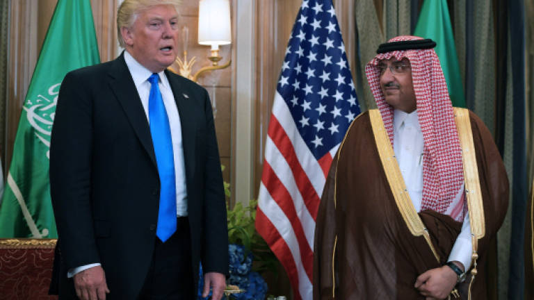 Embattled Trump starts foreign tour with Saudi arms deal