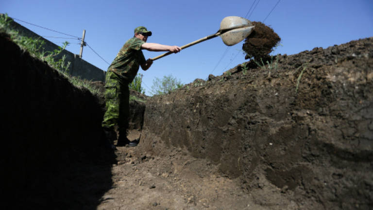 Fearing attack, Russian-backed rebels dig trenches in Ukraine