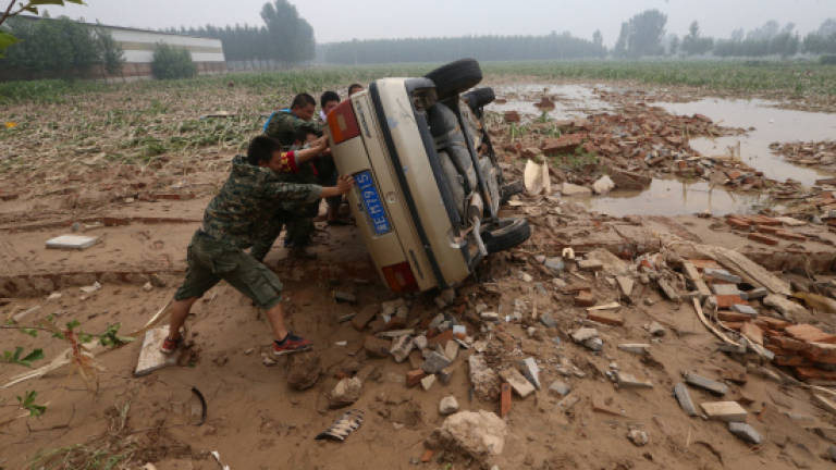 Nearly 300 dead or missing from China flooding