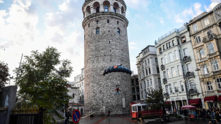 Turkish daredevil jumps from Istanbul's Galata Tower in modern first