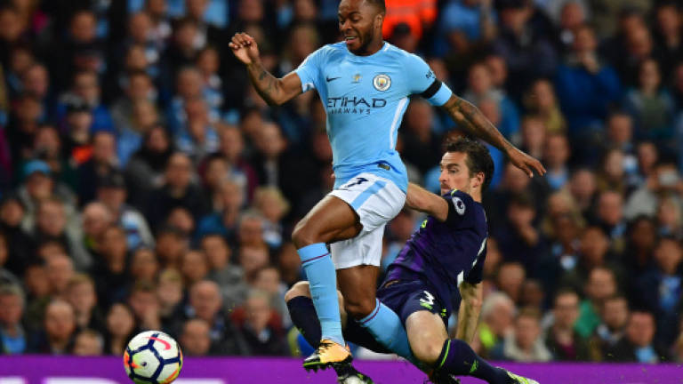 Sterling rescue act spares 10-man Man City