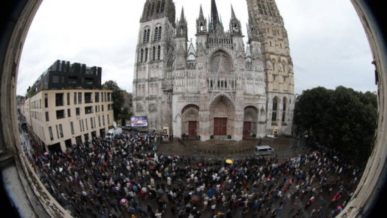 France lays to rest priest slain by jihadists
