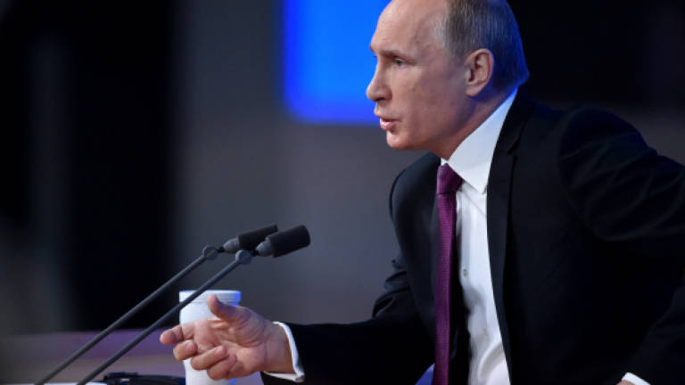 Putin promises economic recovery, digs in on Ukraine