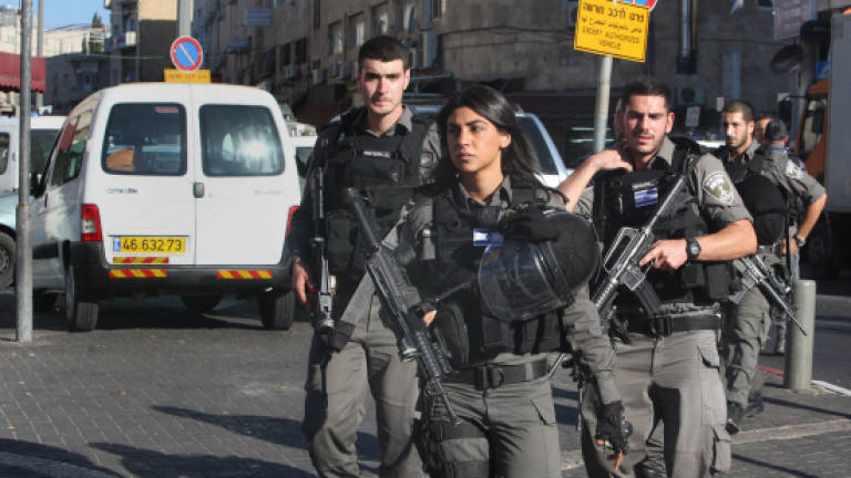 Palestinian stabs 2 officers, shot in new surge of violence