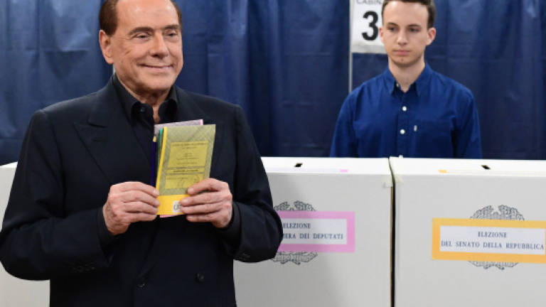 Berlusconi's right-wing coalition ahead in Italy vote: Exit polls