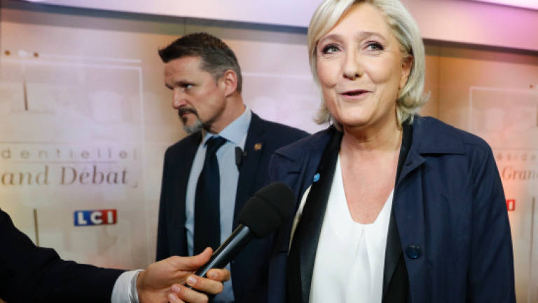 France's Le Pen under fire in first presidential debate