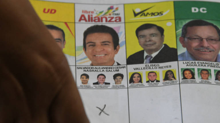 Honduras president keeps lead in disputed vote after recount