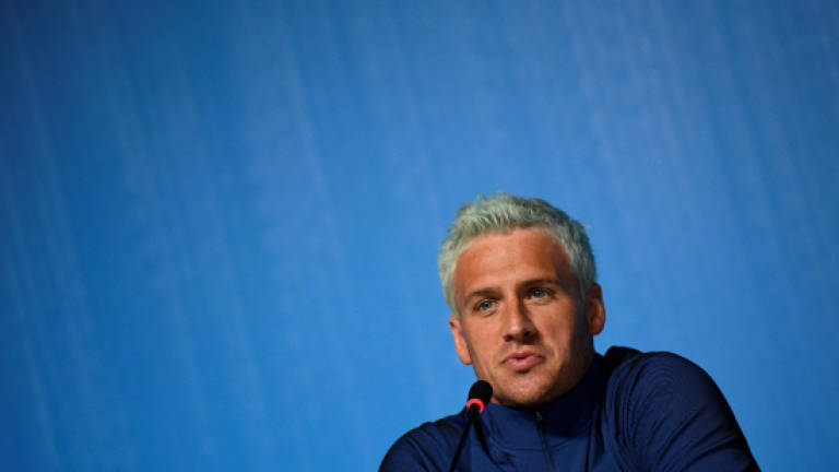 Swimmer Lochte charged over false robbery claim