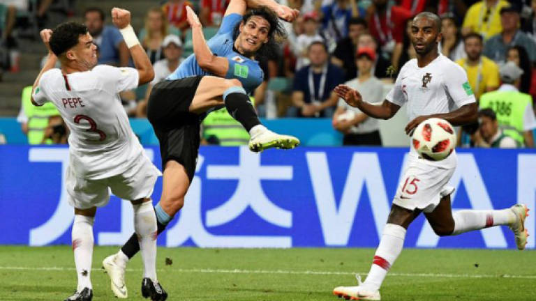 Cavani double for Uruguay sends Portugal and Ronaldo packing