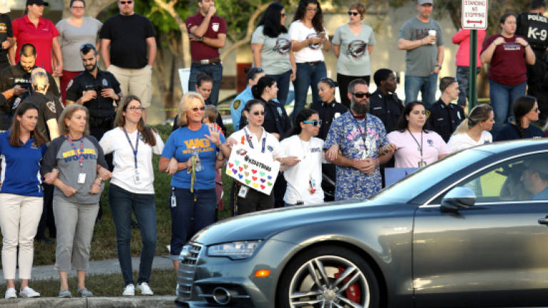 Families surround Florida shooting school as students return