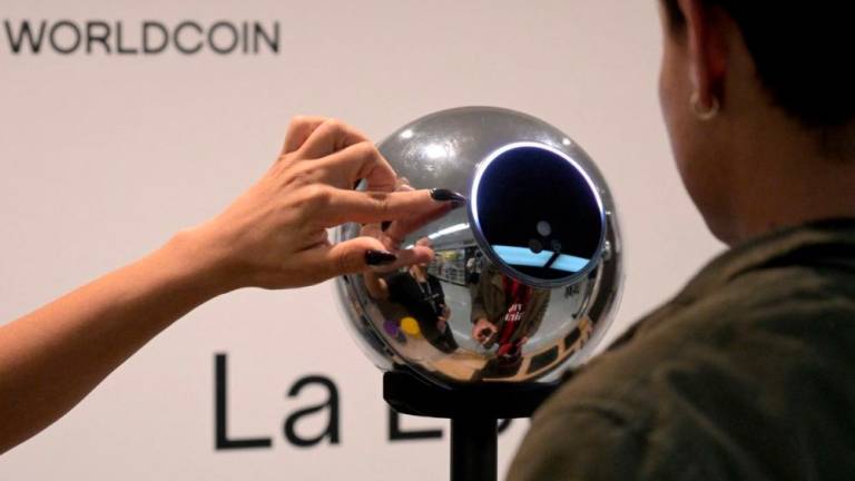 A man has his iris scanned with an orb, a biometric data scanning device, in exchange for the Worldcoin cryptocurrency in Buenos Aires on March 22, 2024.- AFPPIX