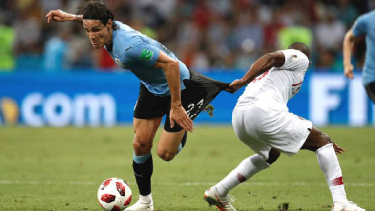 Cavani double for Uruguay sends Portugal and Ronaldo packing