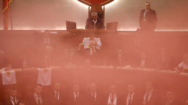 Opposition MPs in Albania throw smoke bombs in parliament