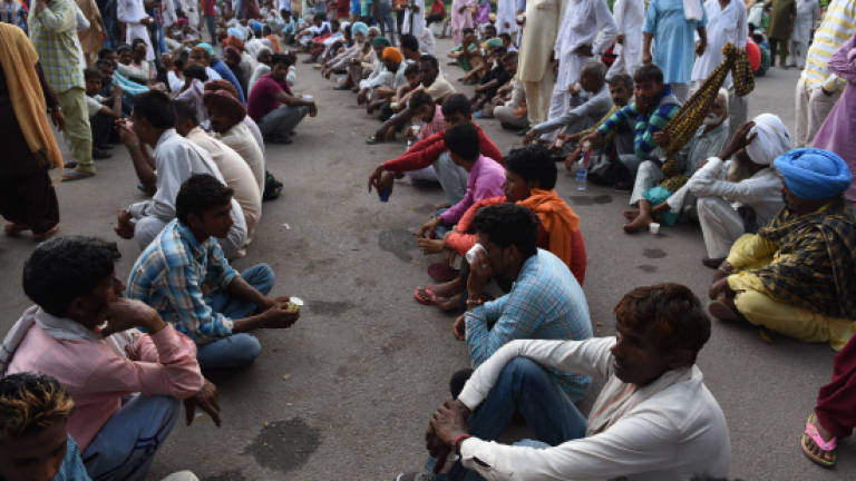Indian cities in lockdown as 'guru in bling' awaits rape verdict